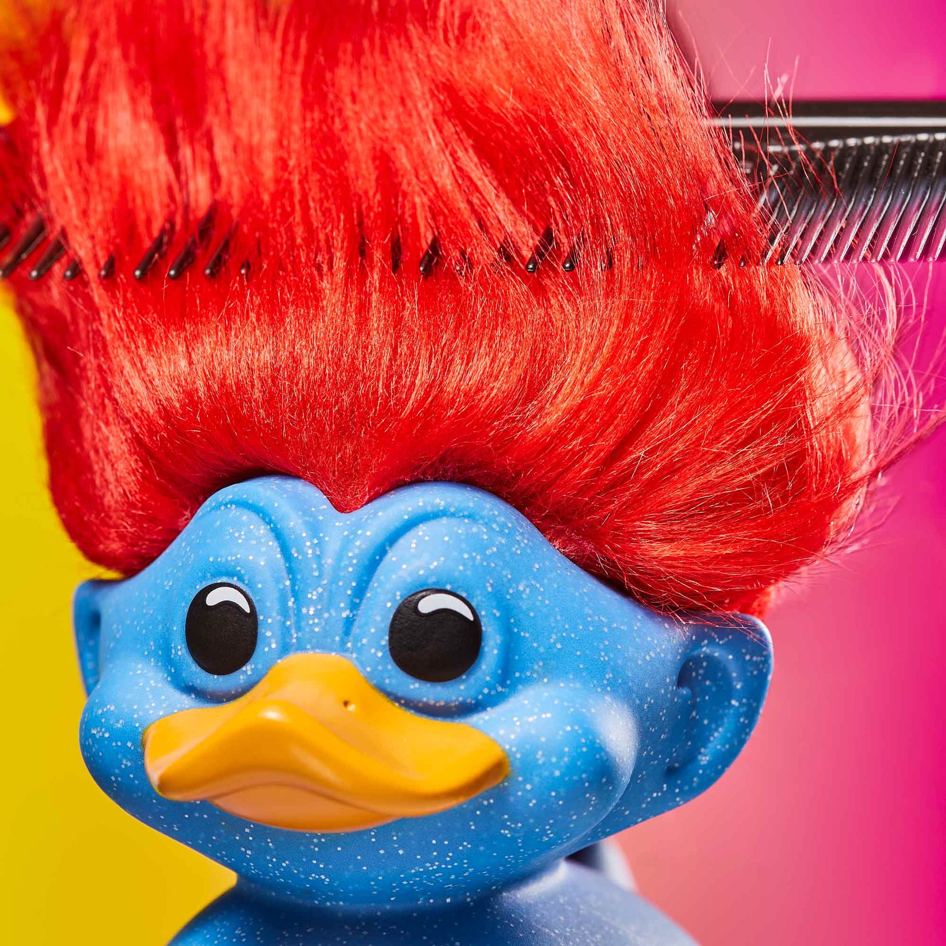 Close-up of Glitter Blue Troll TUBBZ with vibrant red hair